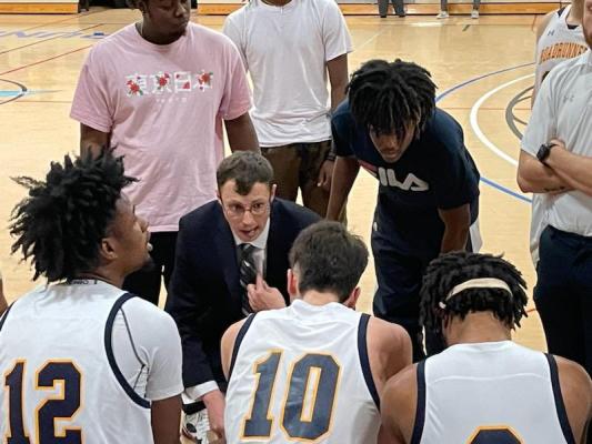 Mountain Gateway men's basketball coach Benjamin Kluzak talks to his team during a game with Hocking College in Clifton Forge. Photo by Steve Hemphill.