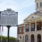 A photo of the Danville courthouse, with a historical marker about Bloody Monday in the foreground.