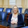 State legislator sits at desk.