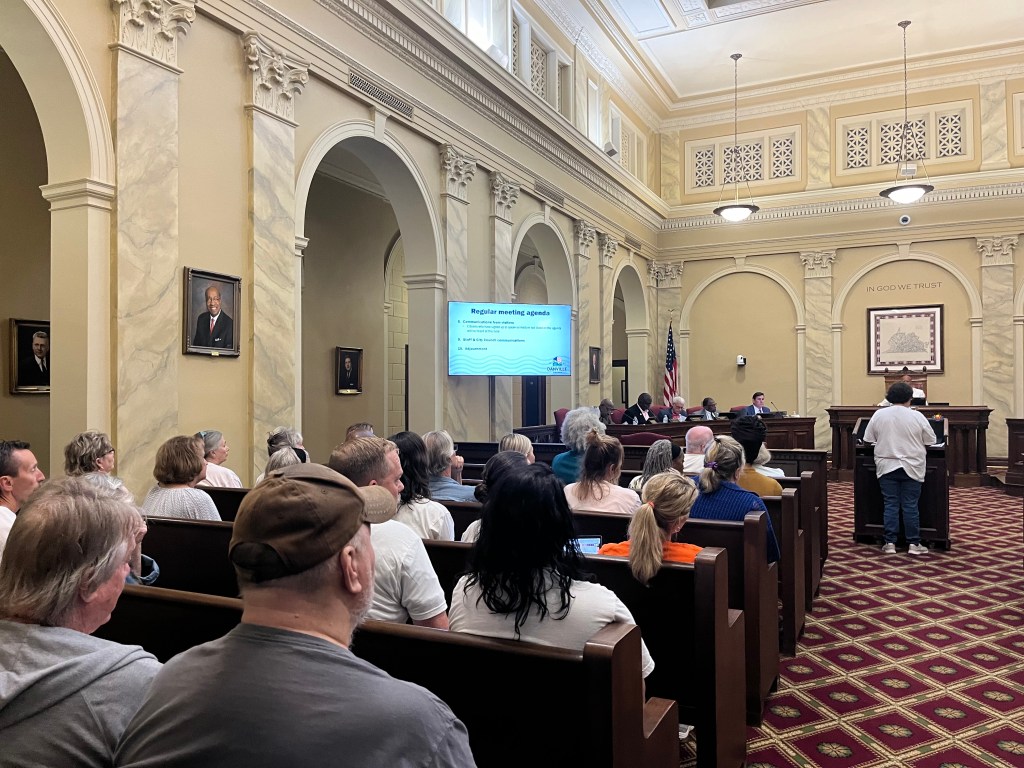 members of Danville Deserves Better pack the City Council meeting, wearing their white campaign t-shirts