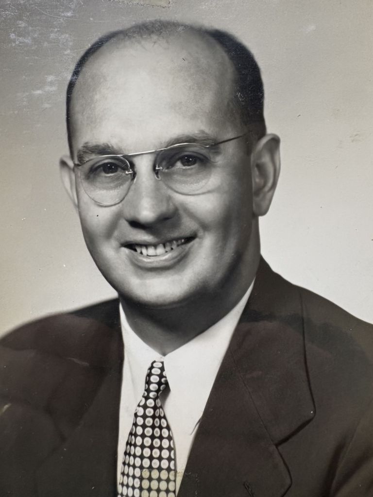 A black and white image of a man with glasses in a suit, Charles Womack, Danville city councilman and white civil rights activist.